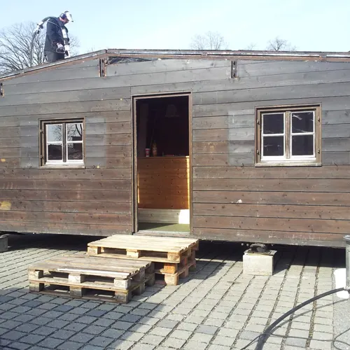 Lackierte Holzhütte vor dem Trockeneisstrahlen Lackierte Holzhütte vor dem Trockeneisstrahlen